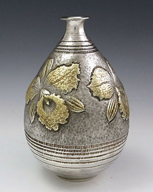Japanese silver vase with gold orchid by Tsuchiya Kyohei
